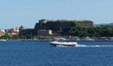 A hydrofoil boat speeds past the New Fortress